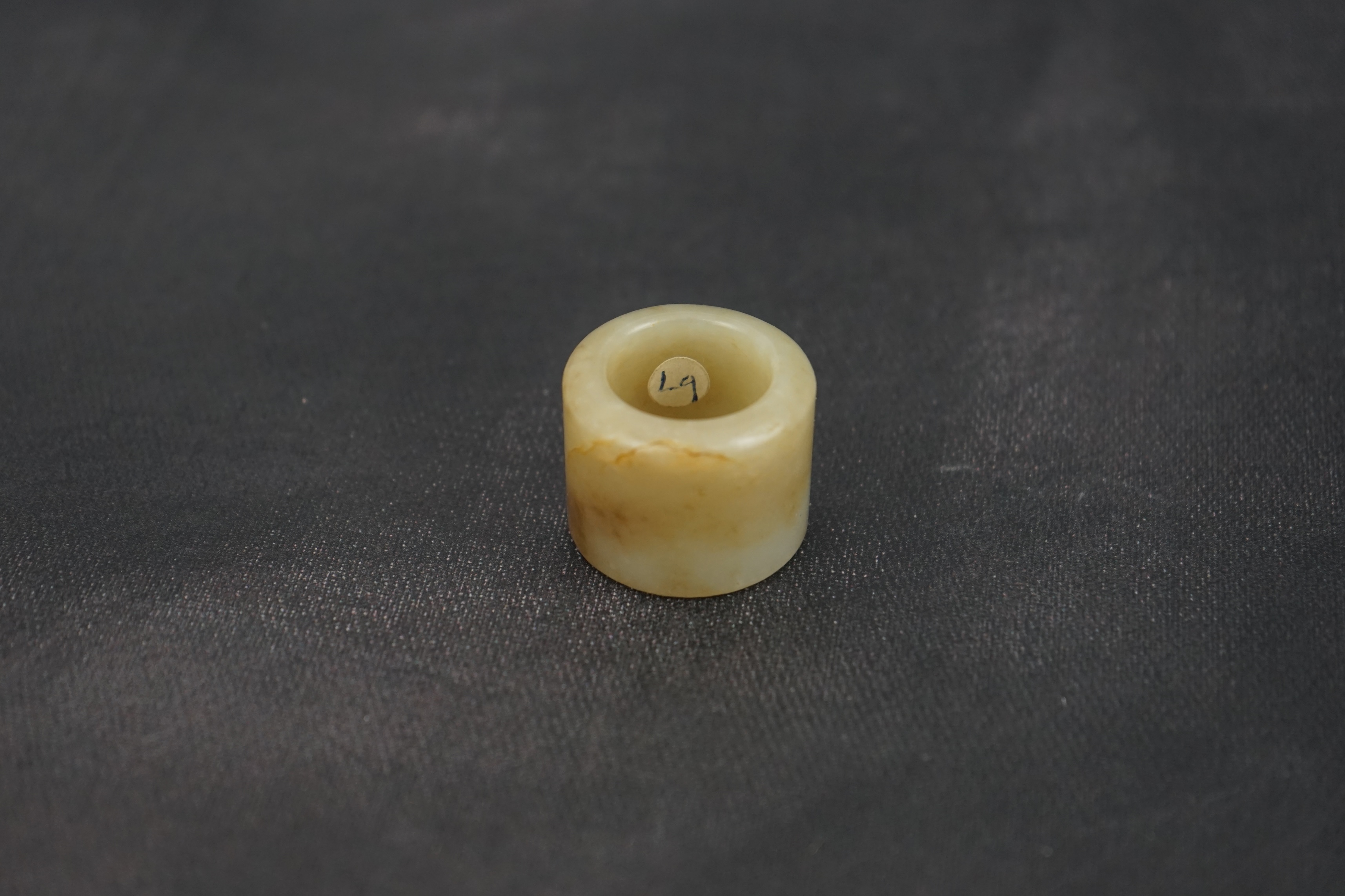 A Chinese pale celadon jade archer's thumb ring, 18th/19th century